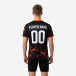 Back view of bold orange custom soccer training jersey with sublimated lava-crack pattern and player name and number print zones