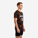 Custom orange soccer training jersey for men, left side view showing full lava-crack print and orange sleeve cuffs