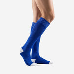 Bold royal blue custom soccer socks side profile view showing over the calf length and white contrast toe
