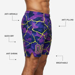 Back view of bulk custom basketball shorts in purple and neon yellow showing full all-over crackle-camo sublimation print from waistband to hem