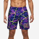 Bulk custom basketball shorts in purple and neon yellow crackle-camo sublimation print with player number 00 on the lower right thigh, front view on male model