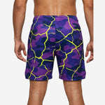 Opposite side view of custom polyester basketball shorts in purple camo and neon yellow crackle pattern showing hem split and waistband detail
