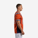 Side view of orange and navy custom American football jersey showing full-length navy side panel inset and stripe-banded set-in sleeve