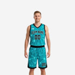 Teal side of the reversible basketball uniform set showing teal base with geometric star-burst pattern and black V-neck binding, front view on adult male model