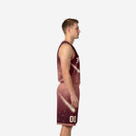 Adult male modeling custom burgundy basketball uniform set with all-over cosmic gradient, V-neck jersey and matching shorts with rose hem binding