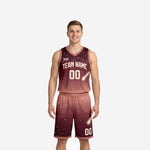 Front view of burgundy basketball uniforms with maroon-to-rose galaxy gradient, star scatter, comet graphic, cream team name arc and number 00 on jersey and shorts