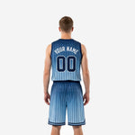 Back view of custom carolina blue basketball uniforms showing player name and number placement on navy-to-blue gradient jersey