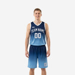 Custom carolina blue basketball uniforms with navy gradient fade, arched team name and number on jersey front, matching shorts with leg number, full set front view