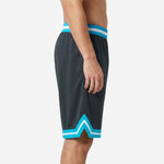 Charcoal custom basketball shorts with teal and white chevron hem trim and striped elastic waistband, side view