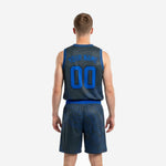 Opposite side view of charcoal and blue sublimated basketball uniform showing armhole binding detail and shorts side panel on male model