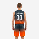 Second side view of sublimated charcoal basketball jersey and shorts highlighting the smooth gradient fade from charcoal to orange at the hem