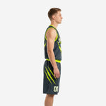 Custom charcoal basketball uniform front view with arced team name, front number, and neon green armhole binding on a male model