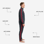 Side detail of charcoal custom soccer track pants with crimson Greek-key stripe running full length of the outer leg seam