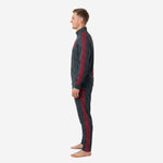 Second side angle of mens custom red and black soccer tracksuit highlighting continuous crimson geometric tape on sleeve and pant leg