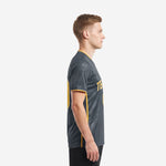 Side view of charcoal men's soccer team jersey with athletic gold side panel stripe and sleeve cuff trim
