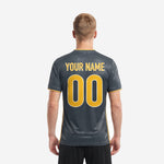 Front detail of charcoal sublimated soccer jersey with geometric tonal pattern and athletic gold V-neck trim