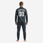 Charcoal grey soccer tracksuit jacket detail with stand collar, white zip stripe, and sublimated chest print zones