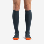 Front view of custom orange and black soccer socks with charcoal body and blaze orange toe panel on male model