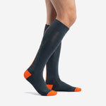 Side view of mens custom soccer socks in charcoal with blaze orange heel and toe contrast panels