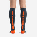 Detail view of custom orange and black soccer socks highlighting reinforced orange heel construction