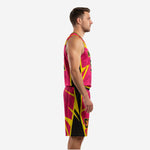Custom basketball uniform kit in hot pink and yellow, left side view showing black panel inserts