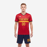 Classic custom red soccer uniform front view showing Athletic Gold chest band team name and number on red jersey with Navy Blue shorts
