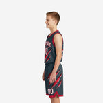 Left-side view of sublimated grey youth basketball uniform showing red armhole binding and claw-slash shorts graphic