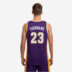 Opposite side view of custom purple and gold basketball jersey displaying full sublimation side panel detail on adult male model