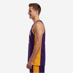 Side view of custom purple and gold sublimated basketball jersey showing gold side panel and bound armhole on adult male model