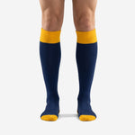 Front view of custom blue and gold soccer socks with Athletic Gold ribbed cuff and Navy Blue body on male model