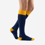 Side view of mens blue and gold soccer socks showing over-the-calf length and Athletic Gold heel cap detail