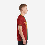 Left side view of a men's custom soccer jersey in Dark Red with Forest Green center stripe and Athletic Gold sleeve cuff trim