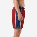 Close detail of crimson soccer shorts athletic cut with navy blue side panel and white stripe trim on adult male model