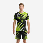 Custom all black soccer uniform with neon green claw-mark sublimation print, front view, full kit jersey and shorts