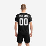 Front detail of custom all black soccer jersey showing arched white collegiate lettering team name and front player number