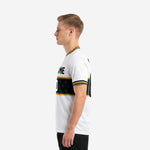 Custom all white soccer jersey with green and gold stripe trim right side view on adult male model