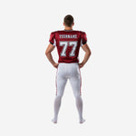 Back view of crimson and white custom american football kit showing back number placement, nameplate area, white shoulder panels, and matching white pants with side stripe