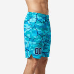 Custom blue and white basketball shorts in aqua camo with navy crackle pattern and sublimated player number 00 on the lower leg panel, worn by an adult male model - side view