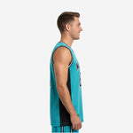 Front view of teal and black custom basketball jersey for clubs with arced team name across chest and large front number 23 on male model