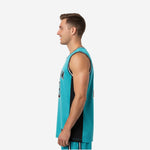 Left side view of teal and black sublimated club basketball jersey showing solid black side panel running from armhole binding to straight hem