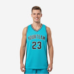 Custom basketball jerseys for leagues in teal and black with arced team name and number 23 on the front, shown front and back on a male model