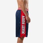 Men's sublimated basketball shorts side view showing vertical team name in white block letters on red side panel running hip to hem