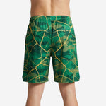 Back view of custom green basketball shorts with full-dye sublimated camo and gold crackle pattern across the entire panel