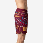 Side view of custom maroon basketball shorts showing swirl sublimation pattern, elastic waistband, and side split at hem