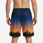 Custom basketball shorts with logo zone at hip, navy gradient fading to orange with skyline hem, front view
