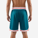 Front view of custom basketball shorts in teal featuring white and coral waistband stripes and bold double-chevron hem design