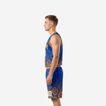 Left side view of custom basketball uniforms with names and numbers showing gold armhole binding and geometric diamond pattern on blue and gold jersey and shorts set