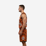Side view of orange and black sublimated basketball jersey and shorts showing full tiger stripe pattern wrapping the torso and shorts