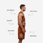 Size and specification chart for orange and black custom basketball uniforms with logo showing youth and adult sizing options