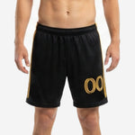 Custom black and gold soccer shorts front view with gold player number on left leg and club crest on hip